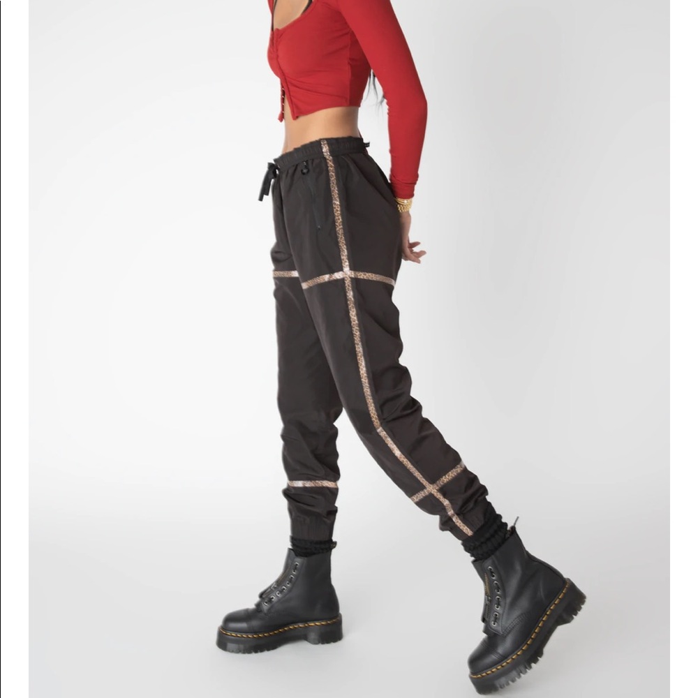 BRAND NEW with tags. Adam Selman windbreaker tapped track pant black/leopard - M